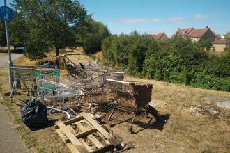 A pile of rubbish cleared from Renhold Brook, including pallets and trollies