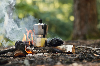 Kettle on a campfire on a woodland floor 