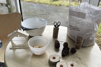 Image of table with items to make bird feeders