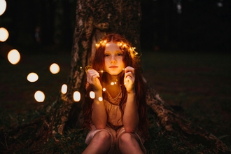 girl holding string lights from pexels.com by Matheus Bertelli