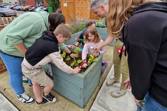 family planting vegetables