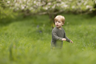 Toddler in the grass by Jon Hawkins - Surrey Hills Photography