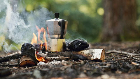 Kettle on a campfire on a woodland floor 