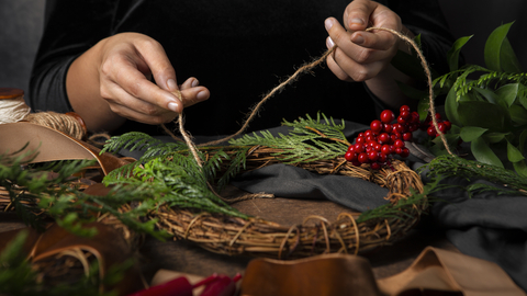 Hands working on making a willow wreath 