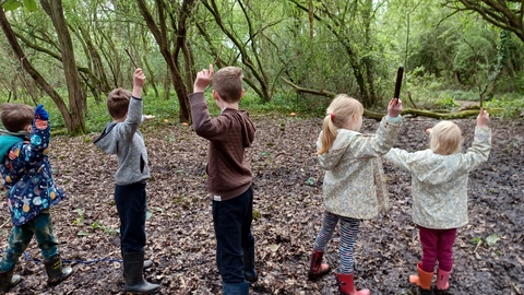 Children with sticks in Oaks Wood Cambourne Nature Reserve by Rebecca Neal