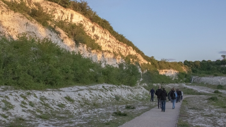 A group walking through chalkland habitat 