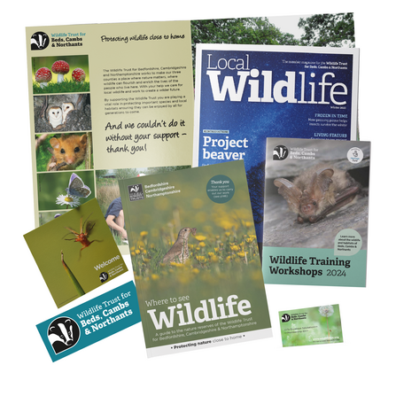 The contents of a membership pack, including a sticker, membership card, the Local Wildlife magazine, wildlife training workshop leaflet and a nature reserve guide