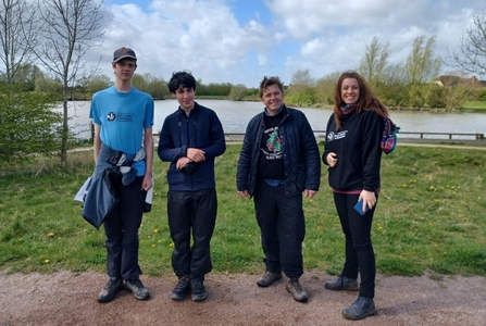 2 members of the Young Peoples Forum, a Wildlife Trust staff member and Dr Nik Johnson standing outside, smiling toward the camera