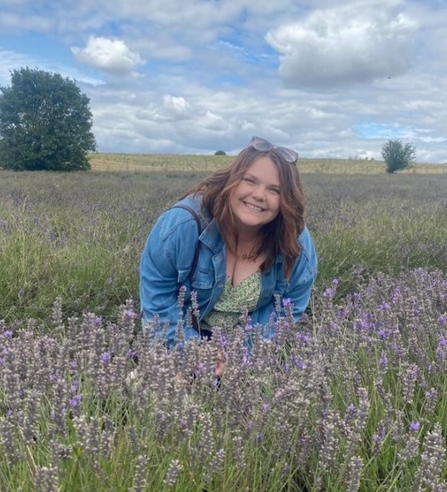 Young People's Forum member Kayleigh smiling towards the camera in a lavender field