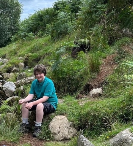 Rufus YPF member sat outside on a rock