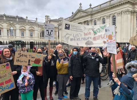 A group of Wildlife Trust BCN staff stand in Cambridge with banners at COP26