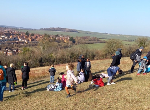 A group on a walk in Luton, looking over the view from the top of the hill